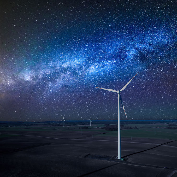 Wind turbines under the night sky