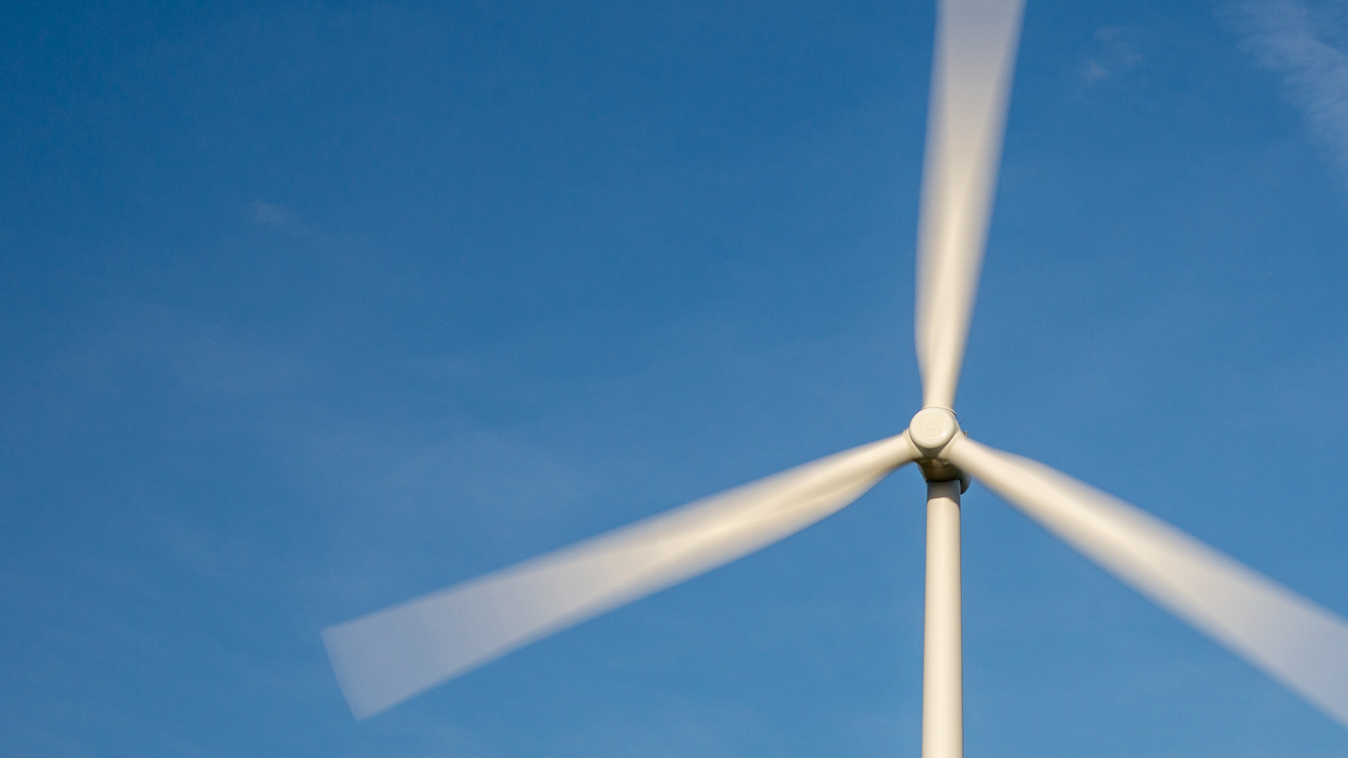 Wind turbine against blue sky
