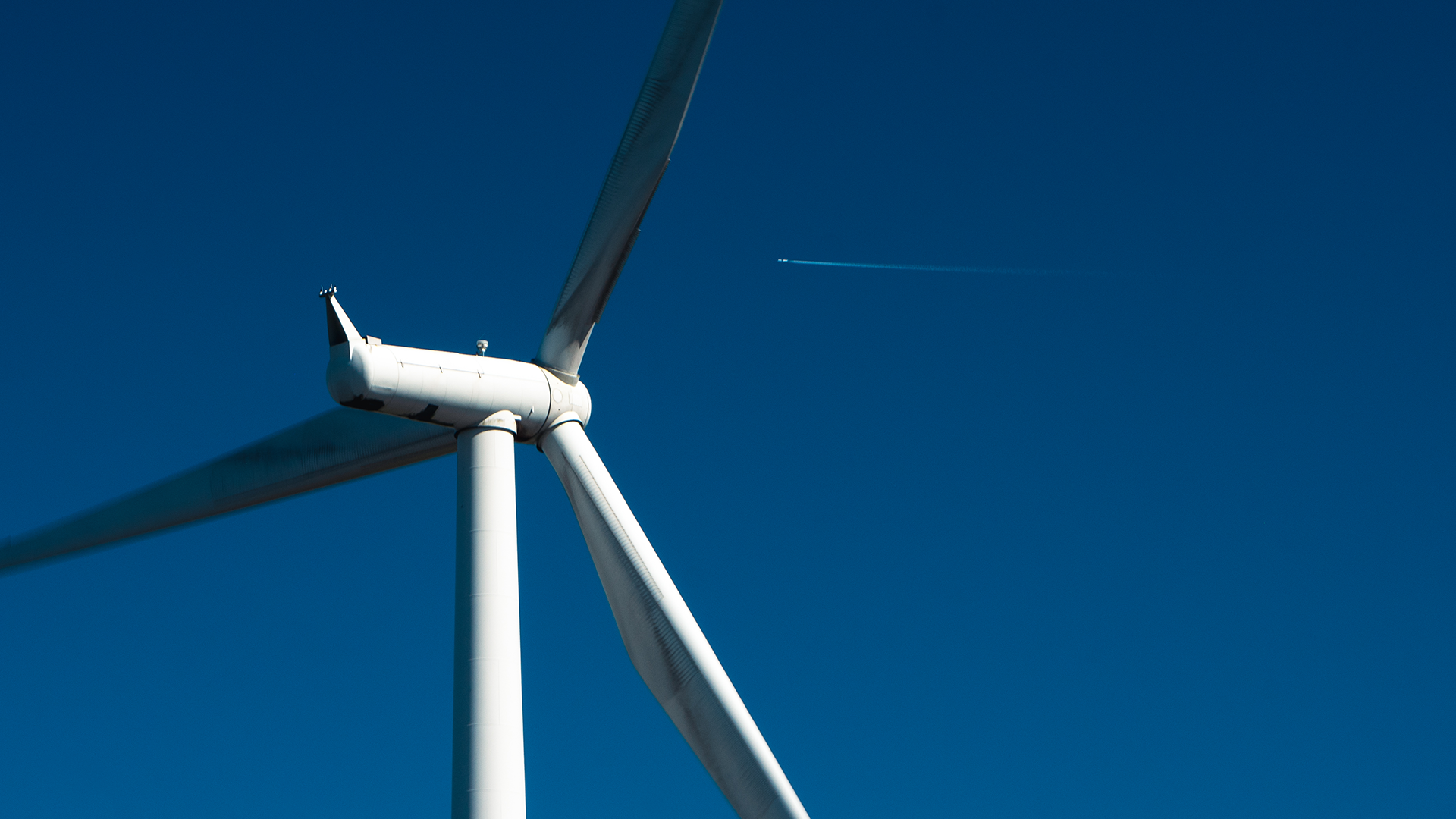 Wind turbine against blue sky